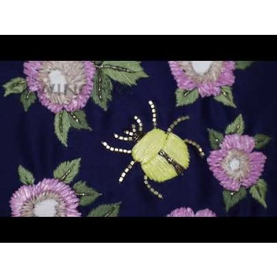 Ashton Bug Embroidery - characterised by its unique materials, natural hues, and dynamic appearance